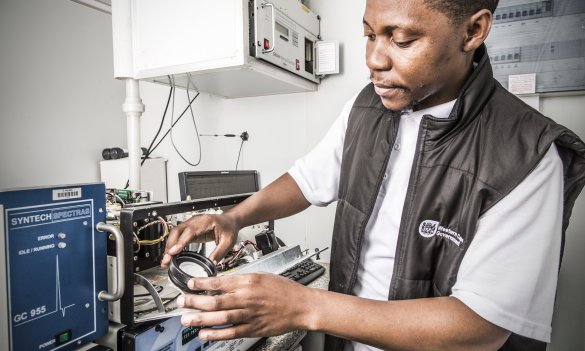 Air Quality Environmental Officer checking analyser machine