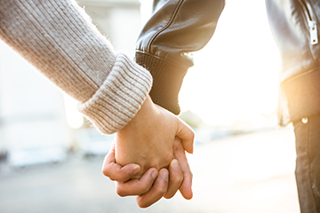 A couple holding hands.