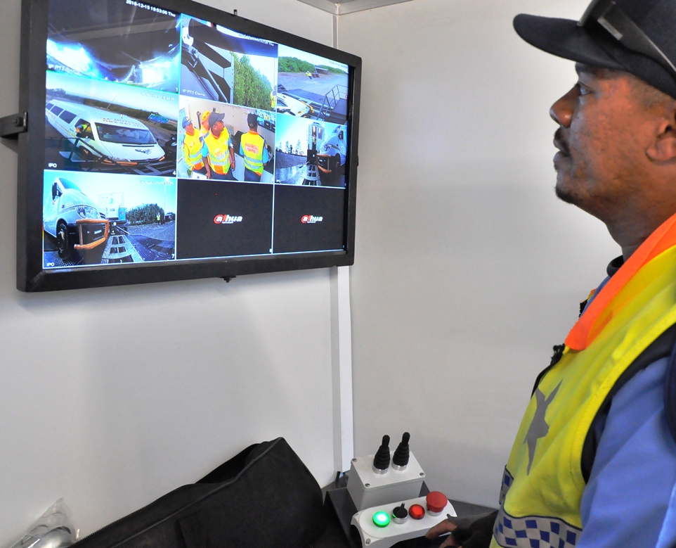 A traffic officer inspects the results of the mobile weighbridge operation.