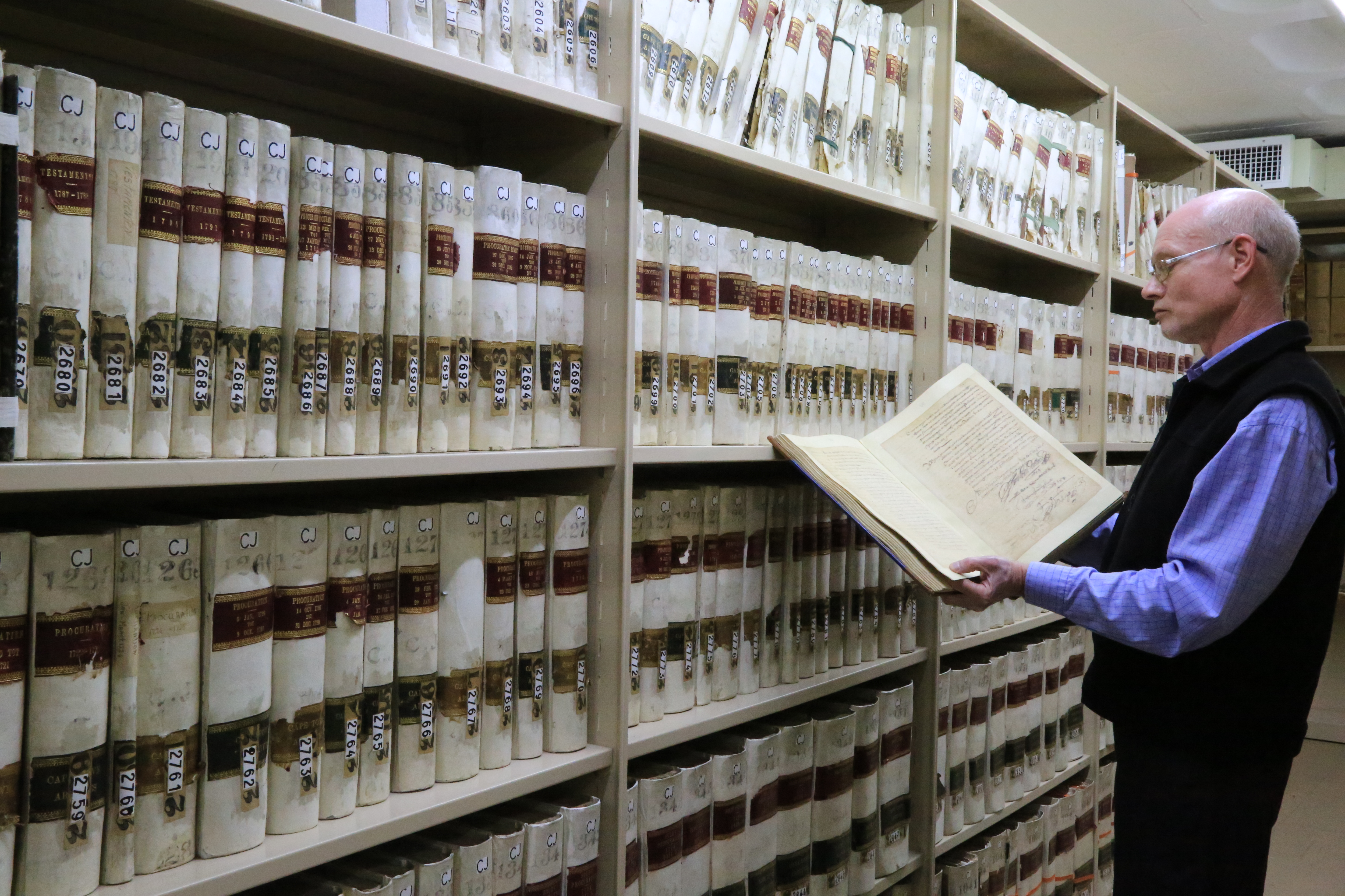 Archives' employee showing archive material