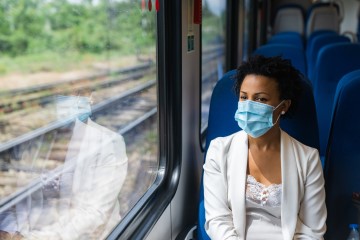 Businesswoman sitting at the window seat on a train looking outside