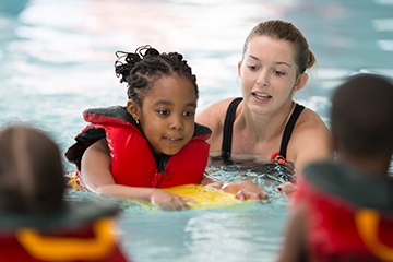 Children receiving swimming lessons.