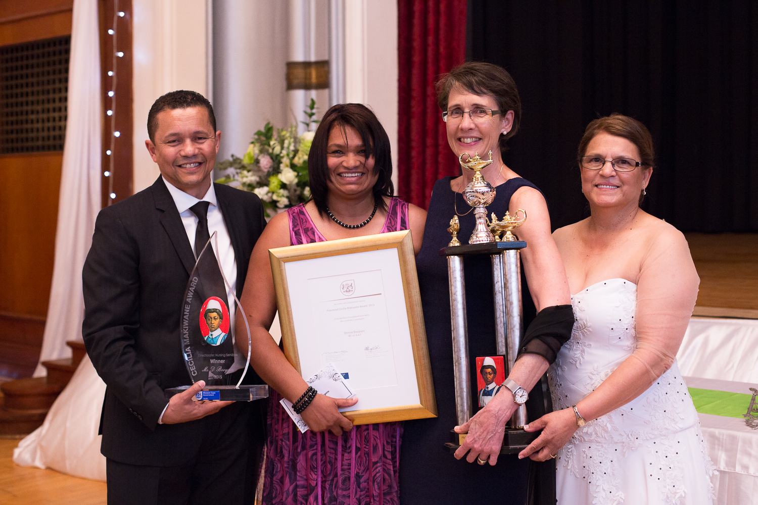 The Cecilia Makiwane Winner (Denise Booysen) (middle) together with Dr Keith Cloete (DDG), Dr Beth Engelbrecht (HOD) and Florence Africa (Director Nursing Western Cape Government Health) showing her trophies after taking the prize.