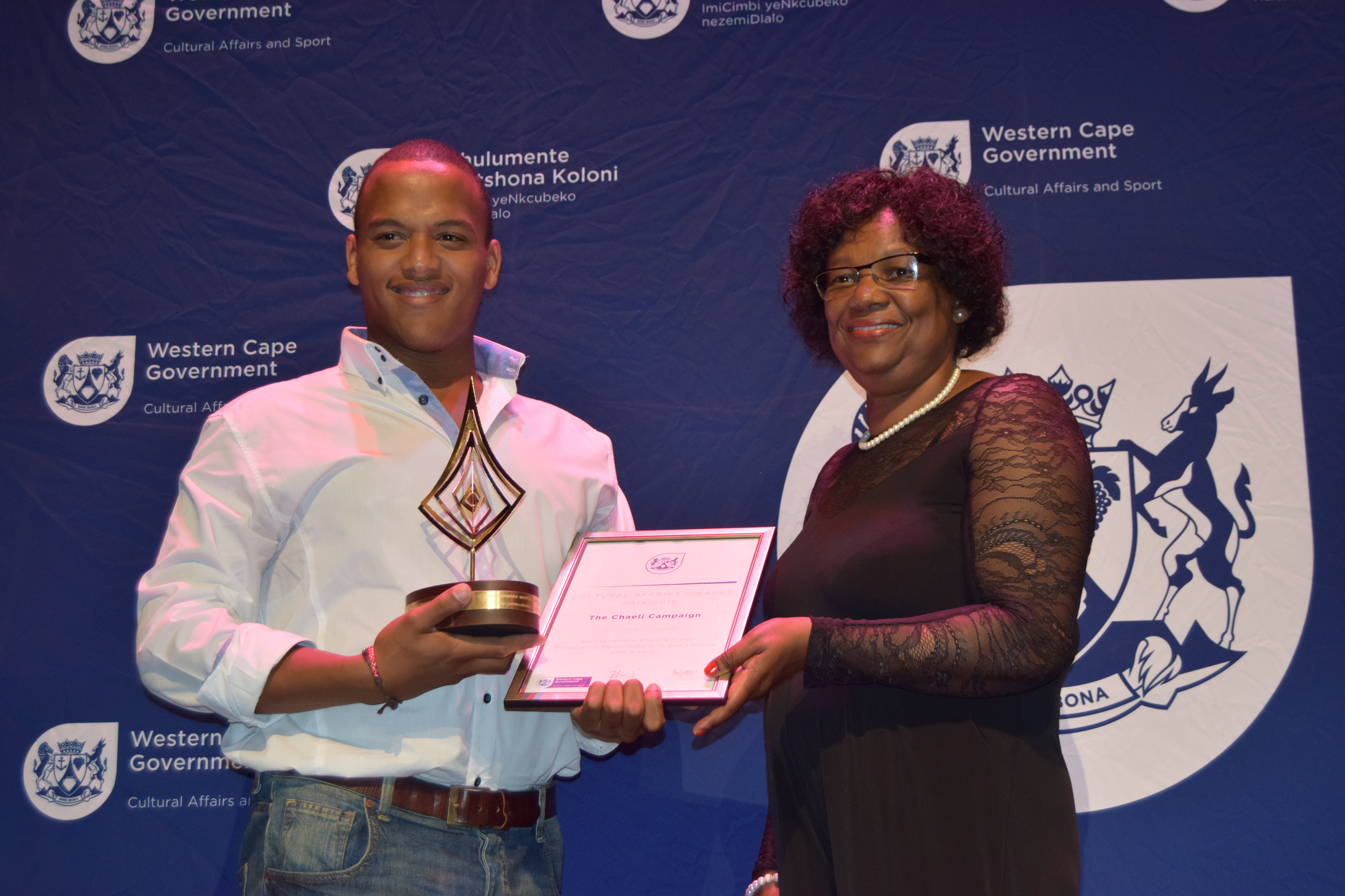 A representative from the The Chaeli Campaign receiving the award for Best Disability Project in the Visual Arts, Performing Arts and Literary Arts from Jane Moleleki