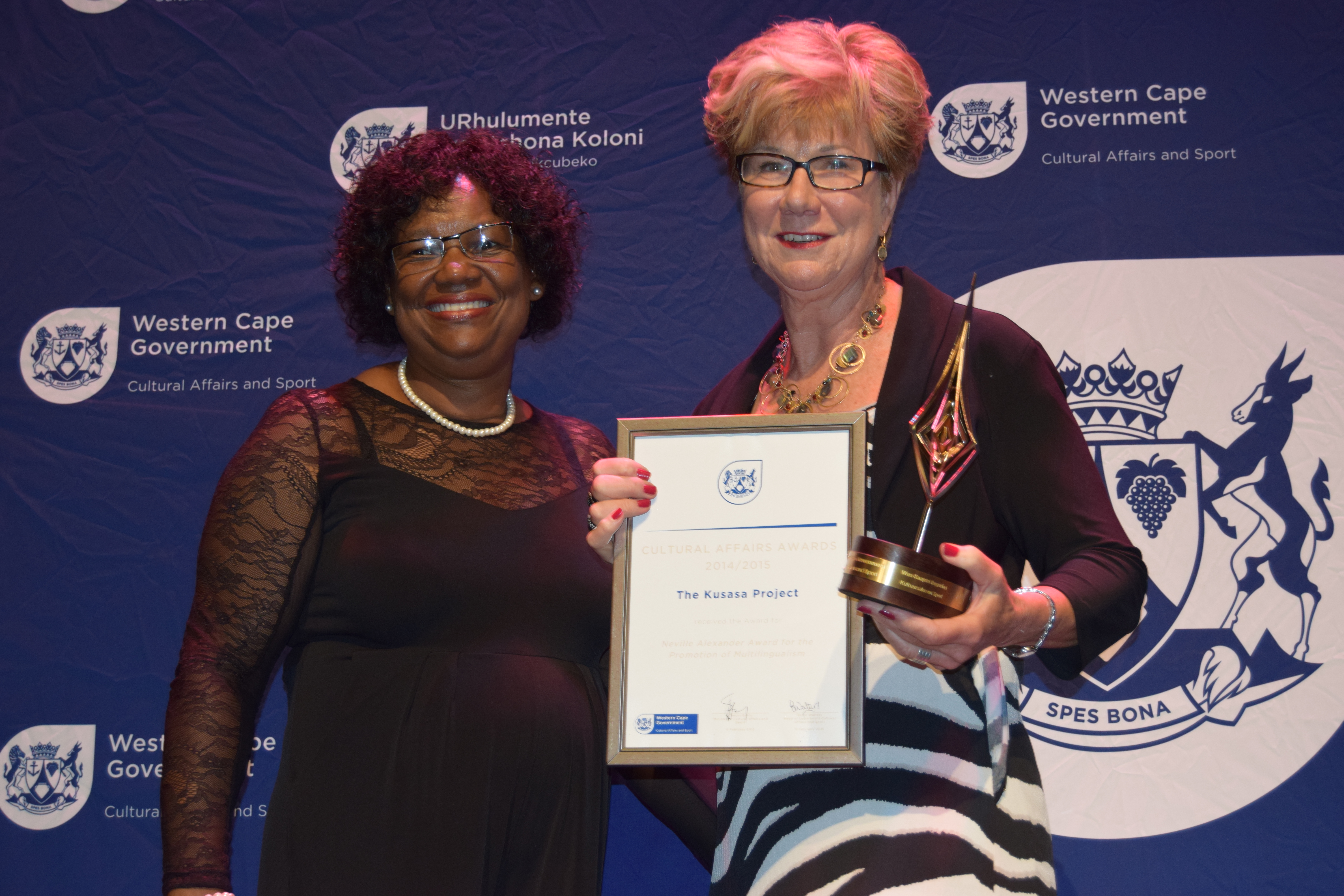 A representative from The Kusasa Project accepting the Neville Alexander Award for the Promotion of Multilingualism from Jane Moleleki