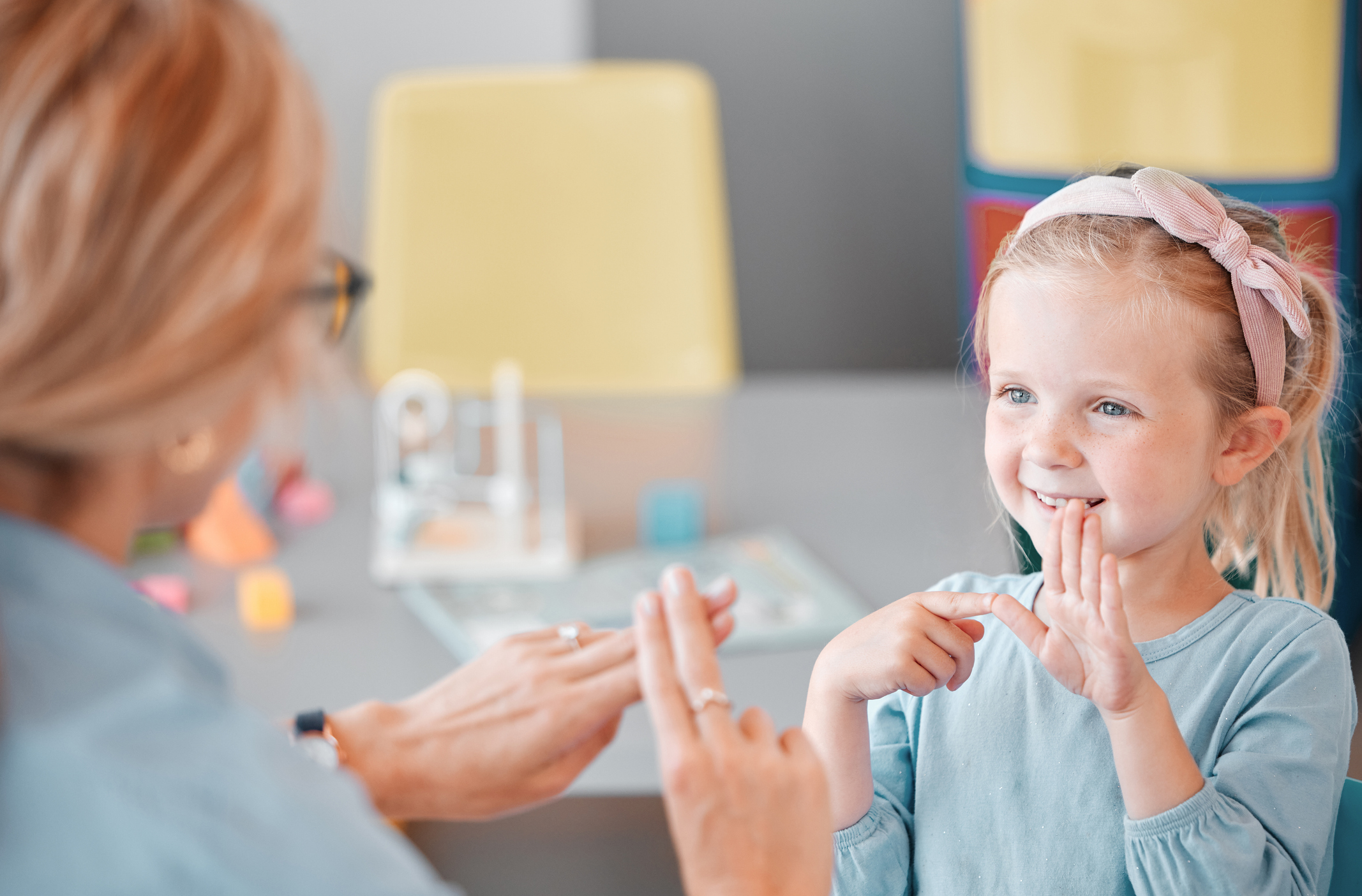 A little girl using sign language 