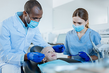 Young girl visiting the dentist. 