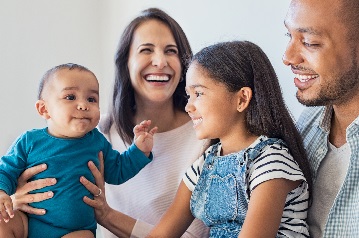 Happy family playing with their children 