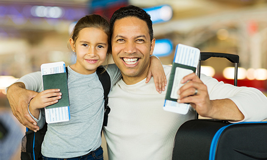 Father and daughter getting ready to board a flight.