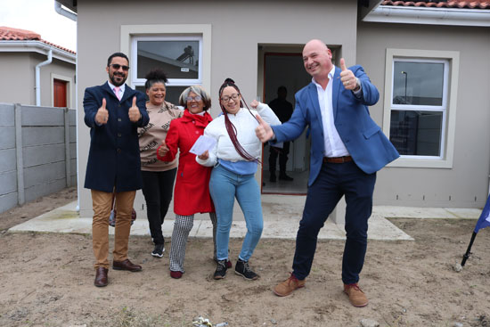 Provincial Minister of Infrastructure, Tertuis Simmers, alongside Mayoral Committee Member (MMC), James Vos, handed over house keys to 10 beneficiaries at the Our Pride housing project, in Eerste River.