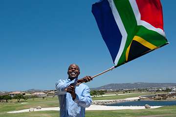 Man waving the South African flag on Freedom Day.