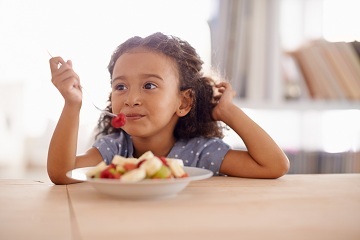 Girl eating fruit