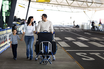 happy family leaving airport