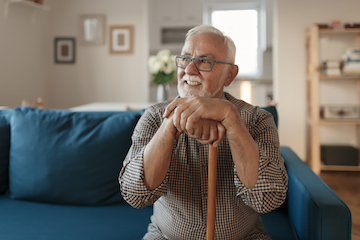 Happy senior man sitting on couch