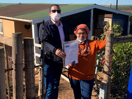 LR - Minister Simmers handing over title deeds to Slangrivier resident Ms Maria Saaiman