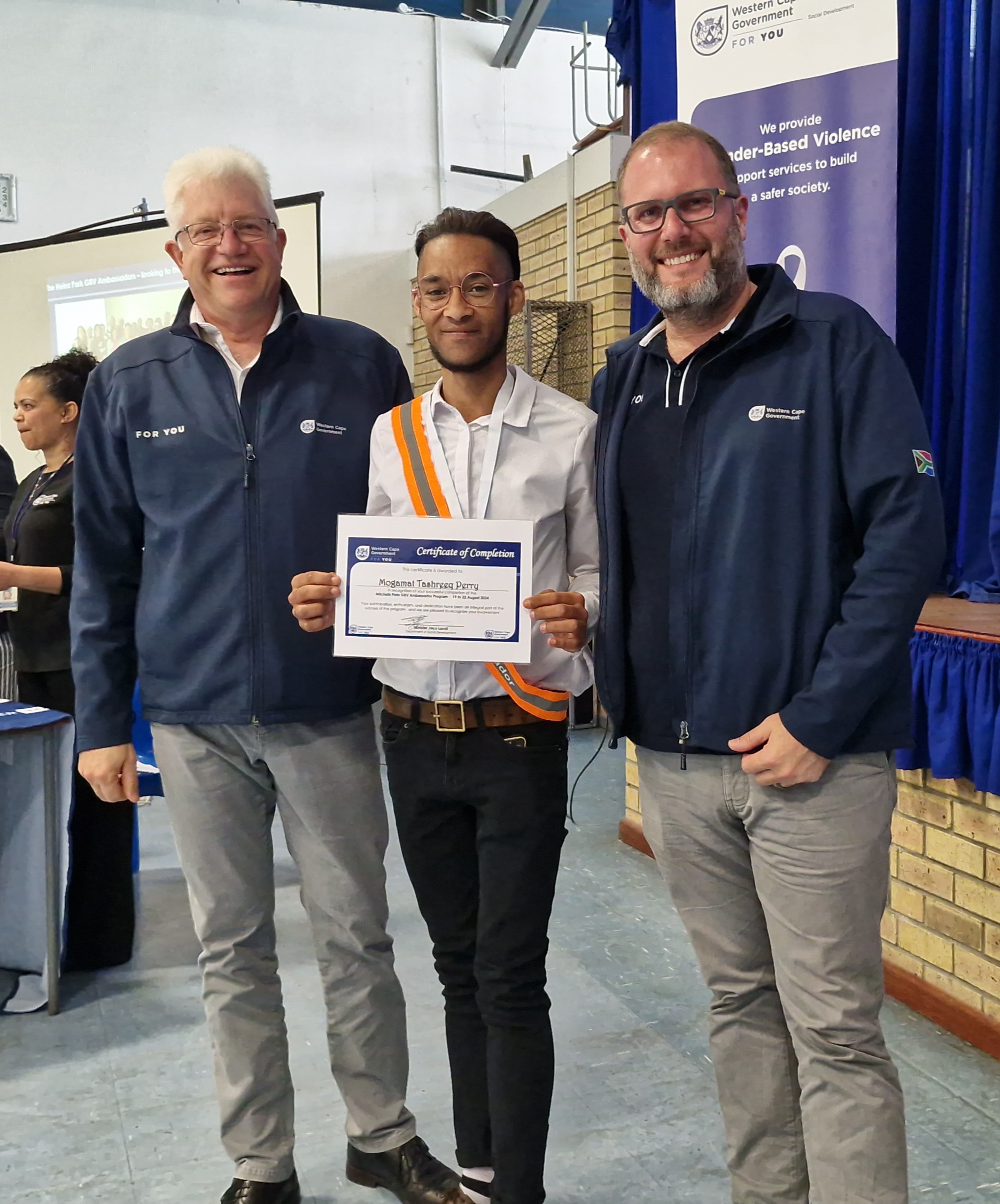 Premier Alan Winde and Western Cape Minister of Social Development, Jaco Londt, with GBV Ambassaor, Tashreeq Perry