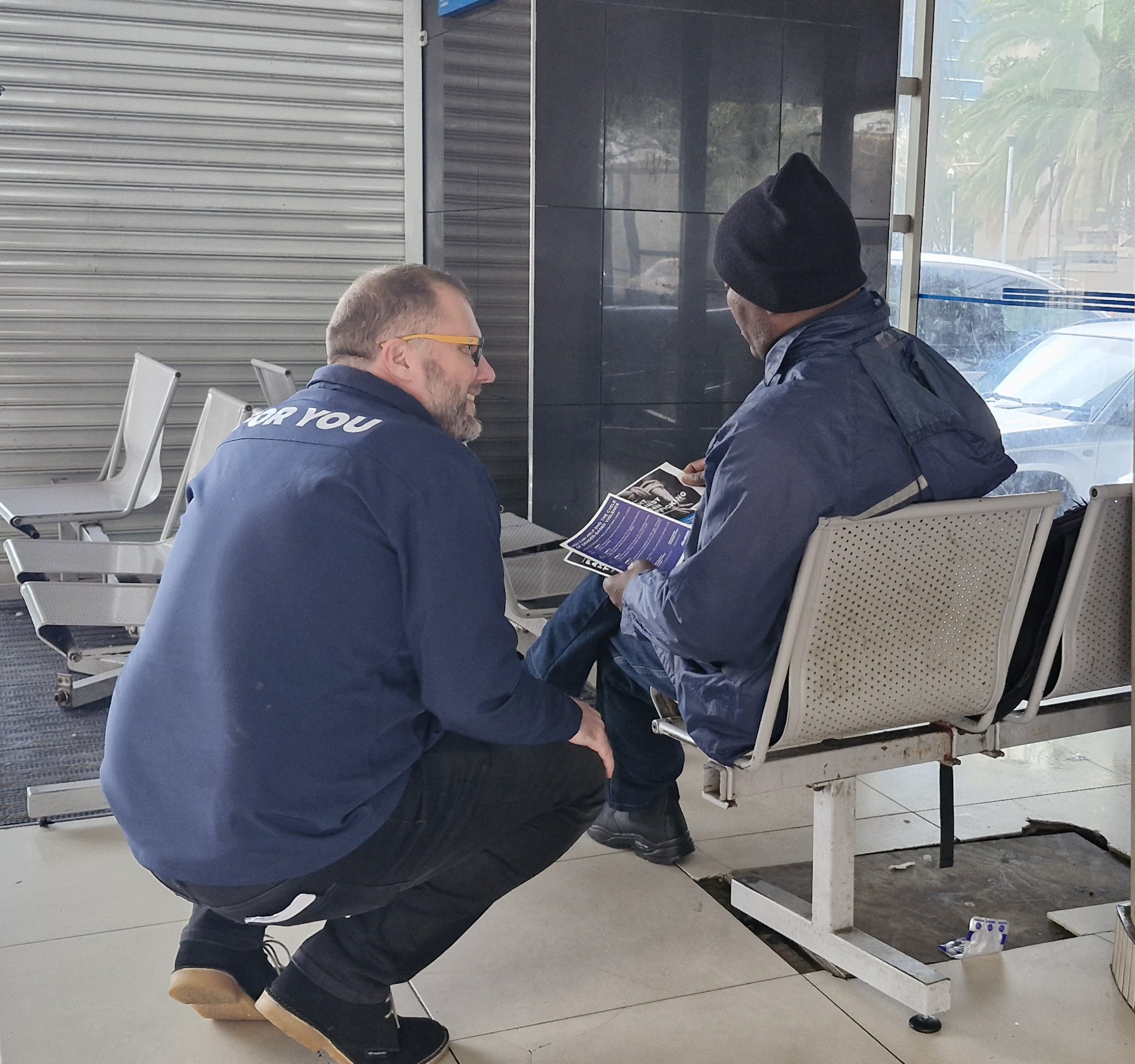 MEC Londt speaking with a commuter