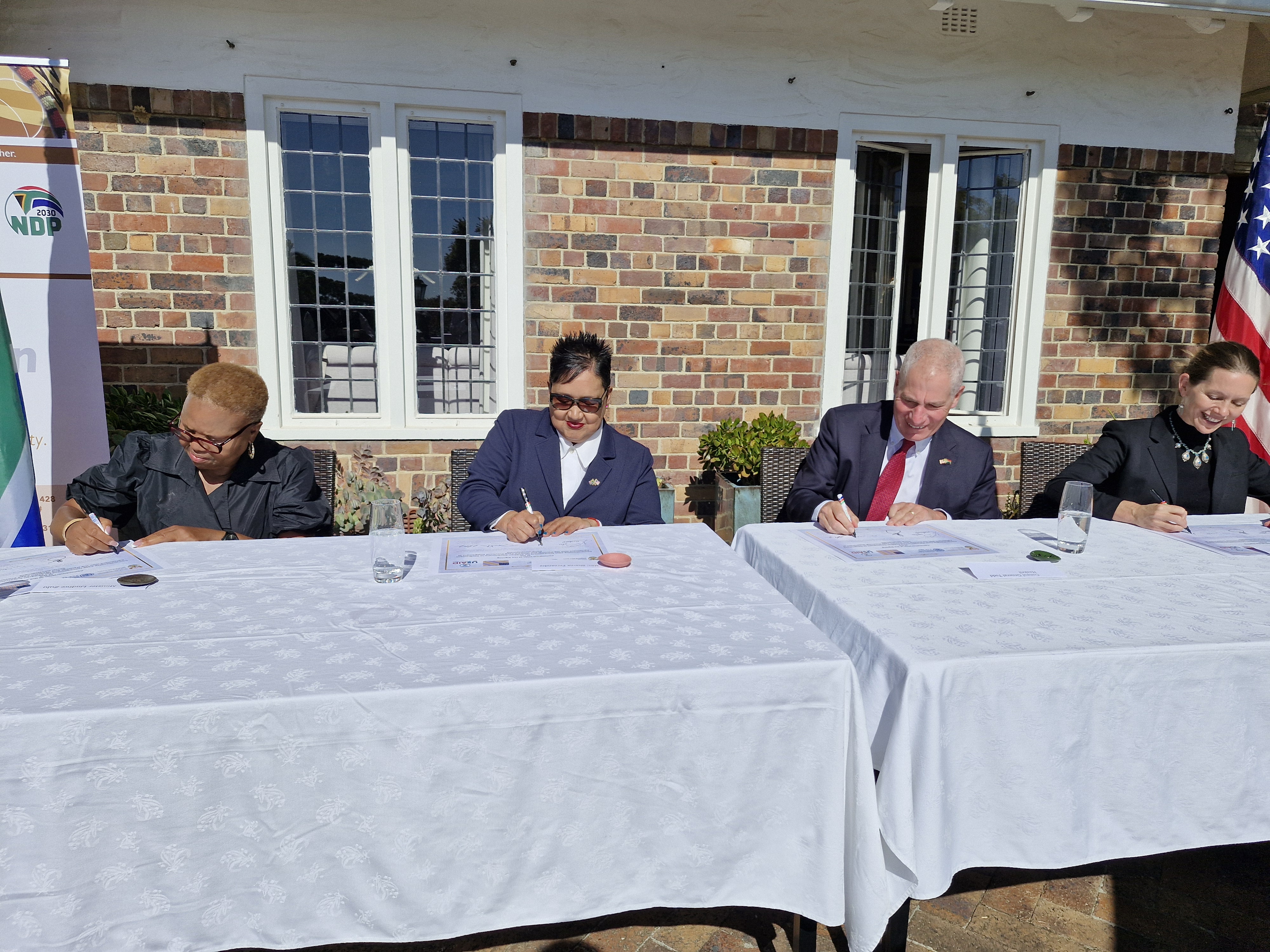 (From left to right) National Minister of Social Development Lindiwe Zulu, Western Cape Minister of Social Development Sharna Fernandez, US Consul General Todd Haskell, USAID Southern Africa Mission Director Leslie Marbury signing.