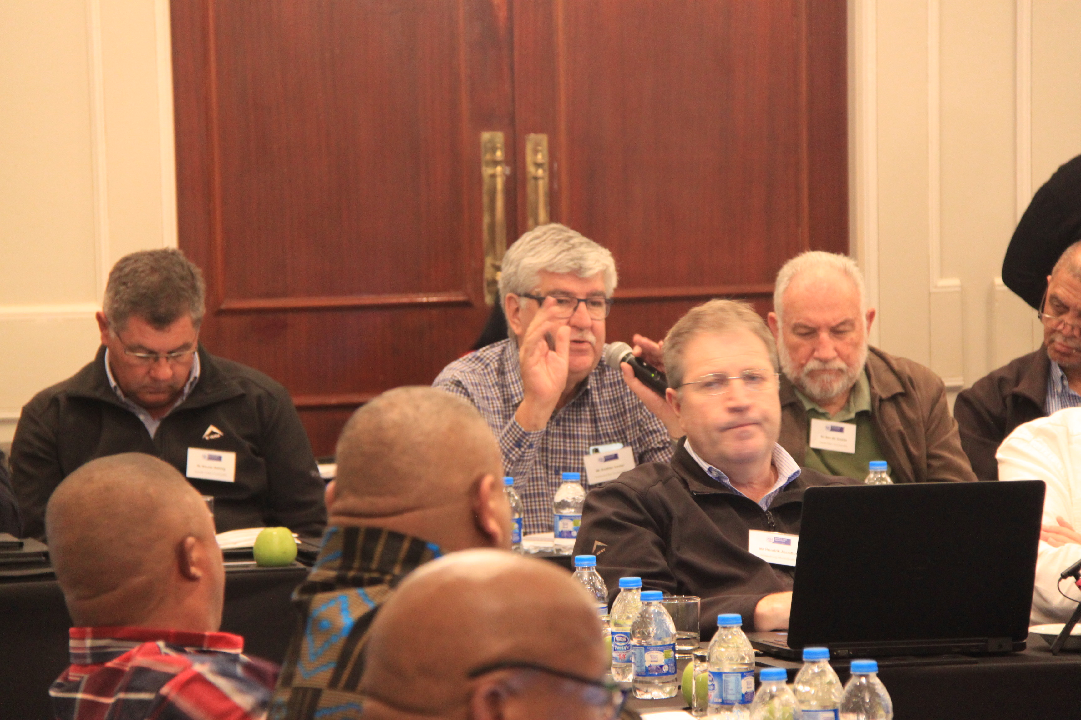 Municipal officials engaging with other participants during a panel discussion.