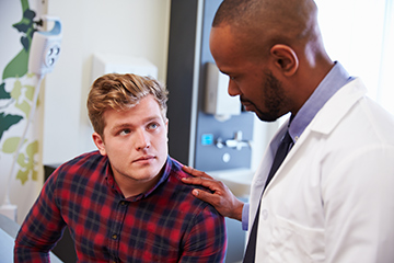 Male patient being examined by the doctor. 