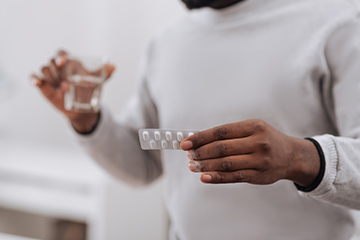 Young man taking his TB medication 