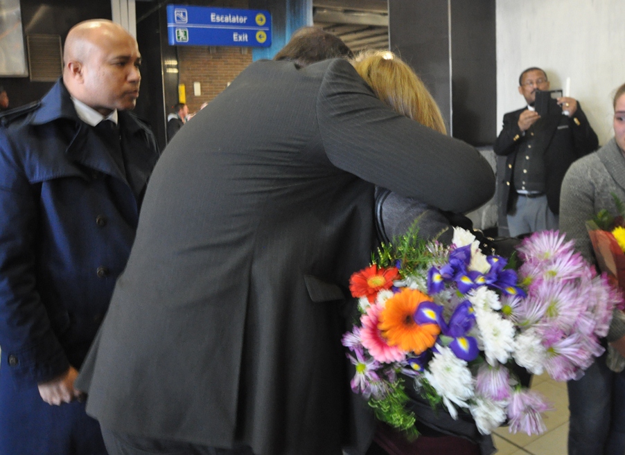 Minister Grant consoles Tania, the wife of Mr Botha.