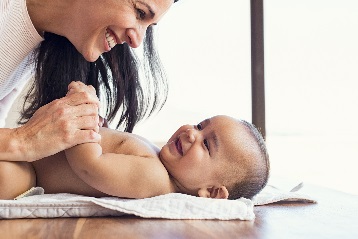 Mommy and baby laughing together