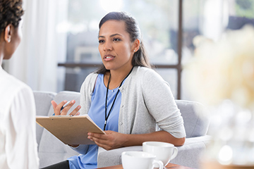 psychologist talking to female patient.