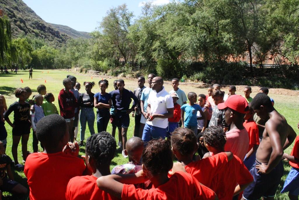 Sicelo Ngxanga (centre) explaining the rules of the various indigenous games