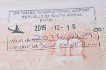 South Africa entry stamp in traveler's passport in OR Tambo international Airport closeup photo