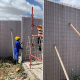 Workers fitting the panels