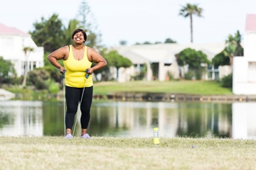 Woman exercising outdoors with water background