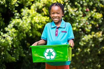 Young boy recycling 