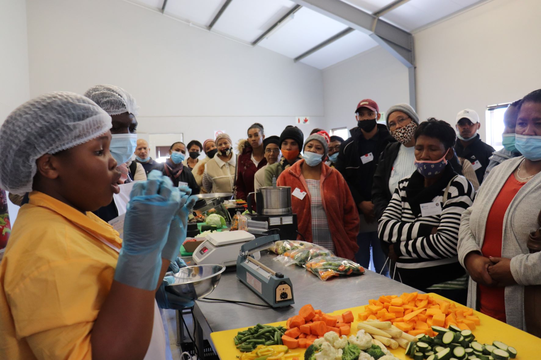 Ziyande Hadebe demonstrating vegetable processing.